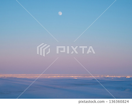 The moon rising over the frozen sea. 136360824