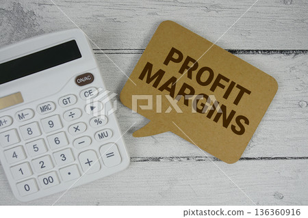 Profit Margins text with calculator on wooden background Profit Margins text with calculator on wooden background 136360916
