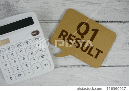 1st Quarter Financial Report text with calculator on wooden background 136360917