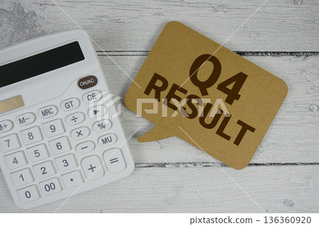 4th Quarter Financial Report text with calculator on wooden background 136360920