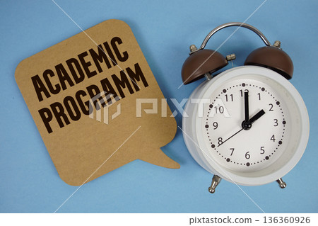 Academic Programm text with alarm clock on blue background 136360926