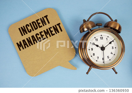 Incident Management text with alarm clock on blue background 136360930