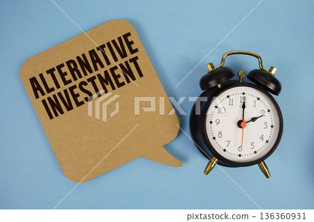 Alternative Investment text with alarm clock on blue background Alternative Investment text with alarm clock on blue background 136360931
