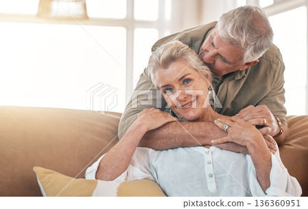 Senior, portrait and a couple kiss and hug on the living room sofa for love, care and bonding. Happy, house and an elderly man and woman with romance together for gratitude, retirement and kindness Senior, portrait and a couple kiss and hug on the living room sofa for love, care and bonding. Happy, house and an elderly man and woman with romance together for gratitude, retirement and kindness 136360951