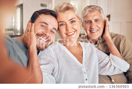 Man, elderly parents and selfie in home, portrait and embrace with love, care and bonding for post on web. Family house, mother and father with son for profile picture, photography and social network 136360983