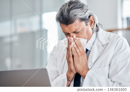 Man, blowing nose and senior doctor sick with allergy, covid or virus in hospital or clinic. Elderly medical professional, tissue and allergies for health problem, cold fever and bacteria in winter 136361005