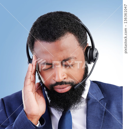 Customer service, studio face and black man headache, stress or sad over telecom fail, salesman crisis or call center burnout. Mental health risk, migraine pain and African person on blue background Customer service, studio face and black man headache, stress or sad over telecom fail, salesman crisis or call center burnout. Mental health risk, migraine pain and African person on blue background 136361047