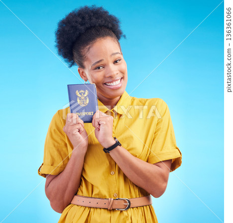 African woman, passport and studio portrait with smile for compliance, identity or paperwork by blue background. Student girl, happy and travel opportunity with immigration document in South Africa African woman, passport and studio portrait with smile for compliance, identity or paperwork by blue background. Student girl, happy and travel opportunity with immigration document in South Africa 136361066