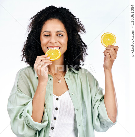 Portrait, orange and woman with a smile, healthy snack and girl isolated against a white studio background. Face, female person or model with fruit, vitamin c and nutrition with happiness or wellness Portrait, orange and woman with a smile, healthy snack and girl isolated against a white studio background. Face, female person or model with fruit, vitamin c and nutrition with happiness or wellness 136361084