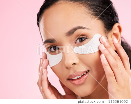 Beauty, face mask and eye patch of a woman with skin care, dermatology and natural glow. Portrait of a young female aesthetic model with cosmetics product for collagen and detox on a pink background 136361092