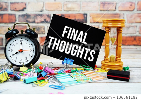 Final Thoughts text on paper card with alarm clock and stationary on wooden background 136361182