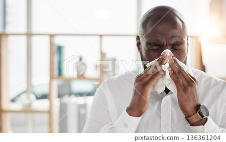 Sick, tissue and businessman blowing his nose in the office with cold, flu or sinus allergies. Illness, medical and professional young African male person with hayfever while working in the workplace 136361204