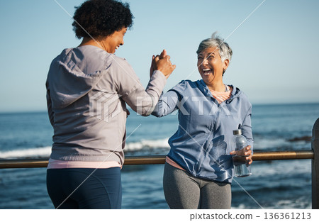 Fitness, high five and senior women friends at beach with exercise, celebration and excited in nature. Sport, people and elderly females with hands in support of wellness, training or success at sea Fitness, high five and senior women friends at beach with exercise, celebration and excited in nature. Sport, people and elderly females with hands in support of wellness, training or success at sea 136361213