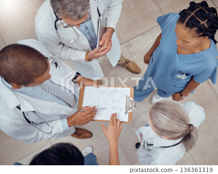 Group of doctors, nurses and checklist in hospital from above, meeting and planning surgery or schedule. Healthcare, discussion and medical staff with clipboard, info and talking together in clinic. Group of doctors, nurses and checklist in hospital from above, meeting and planning surgery or schedule. Healthcare, discussion and medical staff with clipboard, info and talking together in clinic. 136361319