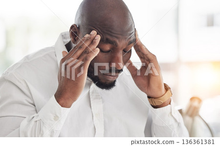 Business man, headache and pain or frustrated in office for financial report, mistake and problem with debt or crisis. Angry, fatigue or tired professional accountant, worker or african person stress 136361381
