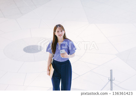年輕女子站在大廳地板上 年輕女子站在大廳地板上 136361423