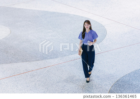 Young woman standing on the lobby floor 136361465