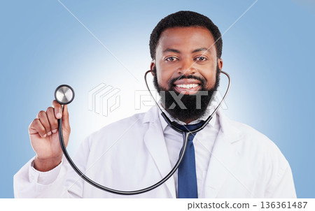 Portrait, stethoscope and man doctor in studio with cardiovascular, exam or consultation on blue background. Heart, health and African male surgeon with medical tool for heartbeat and breathing Portrait, stethoscope and man doctor in studio with cardiovascular, exam or consultation on blue background. Heart, health and African male surgeon with medical tool for heartbeat and breathing 136361487