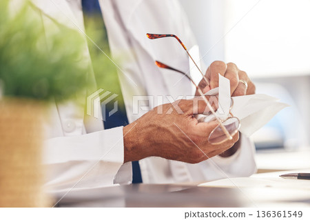 Hands, healthcare and an optometrist cleaning glasses in his office for vision, eyesight or hygiene. Medical, prescription and frame lenses with a medicine professional holding eyewear in an office Hands, healthcare and an optometrist cleaning glasses in his office for vision, eyesight or hygiene. Medical, prescription and frame lenses with a medicine professional holding eyewear in an office 136361549