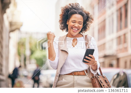 Happy woman, phone and city in celebration for winning, bonus promotion or outdoor sale discount. Excited female person with fist pump in happiness on mobile smartphone for good news in an urban town 136361711