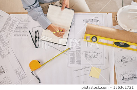 Above, blueprint and hands with notes for architecture, construction planning and building design. Desk, architect and writing a goal for infrastructure ideas, creativity and a contractor strategy Above, blueprint and hands with notes for architecture, construction planning and building design. Desk, architect and writing a goal for infrastructure ideas, creativity and a contractor strategy 136361721