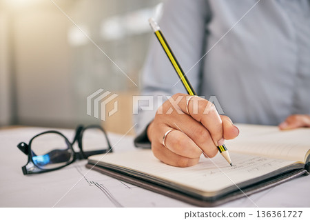 Hand, book and a architect woman writing a note in her journal, diary or planner to remember an appointment. Planning, schedule and notebook with a female engineer sitting in her office closeup Hand, book and a architect woman writing a note in her journal, diary or planner to remember an appointment. Planning, schedule and notebook with a female engineer sitting in her office closeup 136361727