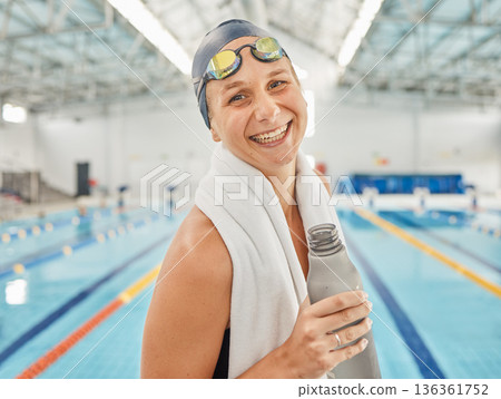 Portrait, swimming pool and woman smile with bottle for exercise, workout or training. Face, happy and swim athlete with water for nutrition, fitness and healthy body, wellness or hydration in Canada 136361752