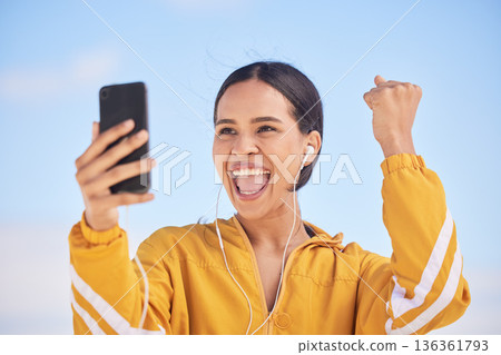 Happy woman, phone and fitness winning in celebration for workout milestone or outdoor achievement. Excited female person and fist pump in happiness for exercise goals or success on mobile smartphone 136361793