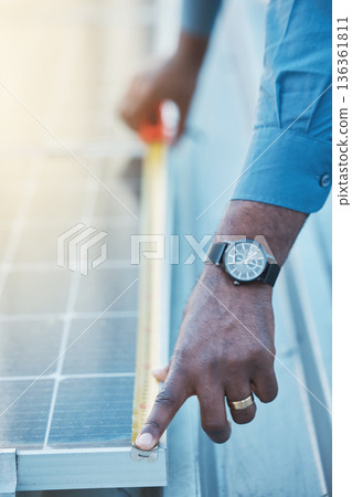 Engineer, hands and tape to measure solar panel on rooftop for sustainable planning, construction and building grid. Closeup of technician, electrician and man with measurement of photovoltaic system Engineer, hands and tape to measure solar panel on rooftop for sustainable planning, construction and building grid. Closeup of technician, electrician and man with measurement of photovoltaic system 136361811