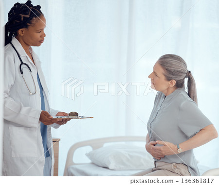 Medical, consultation and doctor with mature patient in discussion on chest pain problem. Professional, clipboard and female healthcare worker talking to elderly woman with heart sickness in hospital 136361817