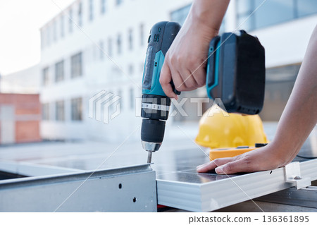Solar panels, hands and electrician with power drill for engineering, grid and building maintenance in city. Closeup of technician, construction tools and upgrade of photovoltaic system on rooftop Solar panels, hands and electrician with power drill for engineering, grid and building maintenance in city. Closeup of technician, construction tools and upgrade of photovoltaic system on rooftop 136361895