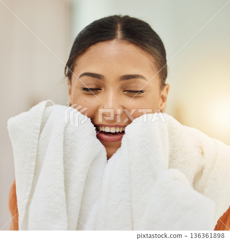 Smile, woman and smell clean towel, fresh scent and fabric after washing cotton or textile for housekeeping in home. Laundry, aroma and happy person with cloth after cleaning for hygiene and wellness 136361898