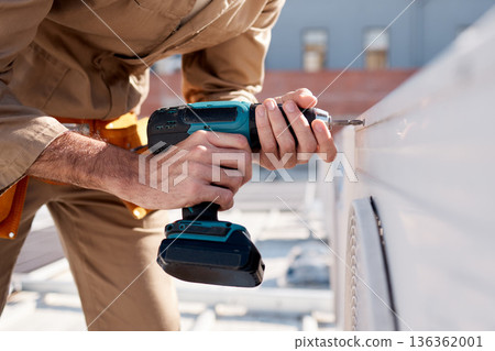 Hands, drill and outdoor with man for air conditioning maintenance, roof or building in city for construction. AC repair, hvac tech or tools for engineer, technician or expert in industry on rooftop Hands, drill and outdoor with man for air conditioning maintenance, roof or building in city for construction. AC repair, hvac tech or tools for engineer, technician or expert in industry on rooftop 136362001
