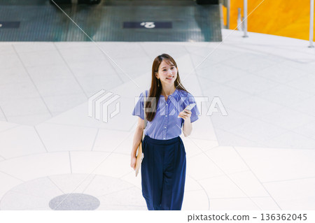 Young woman standing on the lobby floor 136362045