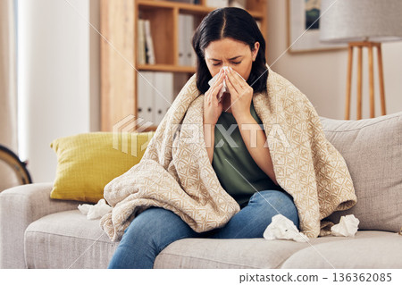 Tissue, blow nose and woman on sofa for home self care with virus, sick and healthcare or allergies. Sinus, flu and person on living room couch with allergy for medical or health and wellness risk Tissue, blow nose and woman on sofa for home self care with virus, sick and healthcare or allergies. Sinus, flu and person on living room couch with allergy for medical or health and wellness risk 136362085