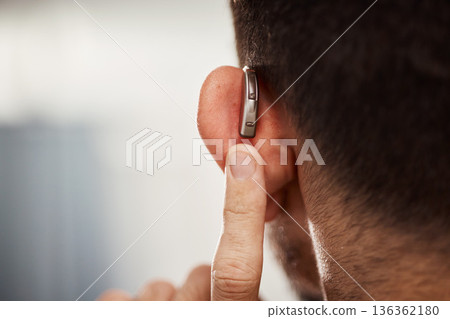 Closeup of ear, hearing aid and man with disability from the back for support, improve listening or amplifier with mockup space. Deaf patient, face and audiology implant to help volume of sound waves 136362180