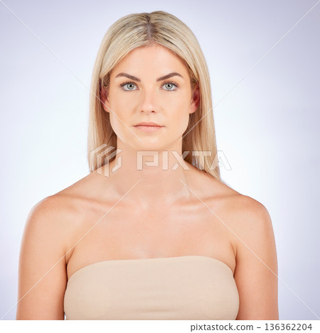 Portrait, blonde hair and beauty of serious woman with natural skincare, aesthetic and studio background. Face, female model and clean dermatology, cosmetics and keratin treatment for healthy glow Portrait, blonde hair and beauty of serious woman with natural skincare, aesthetic and studio background. Face, female model and clean dermatology, cosmetics and keratin treatment for healthy glow 136362204