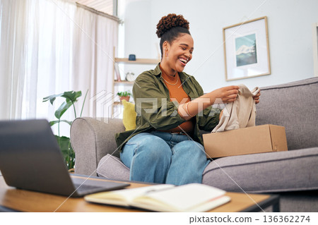 Online shopping, woman on sofa with package and smile, discount fashion retail and laptop in living room. Delivery of clothes, ecommerce and happy person on couch with box from website sale or deal. Online shopping, woman on sofa with package and smile, discount fashion retail and laptop in living room. Delivery of clothes, ecommerce and happy person on couch with box from website sale or deal. 136362274