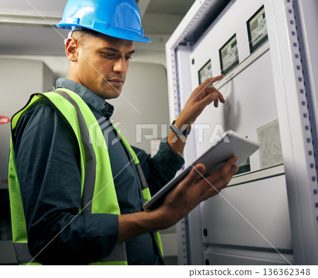 Electrician, engineering and tablet with man in control room for inspection, quality assurance and energy. Electricity, safety and industrial with handyman for maintenance, technician check and power 136362348