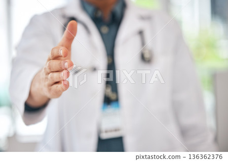 Handshake, offer and doctor introduction, thank you and healthcare deal, success or welcome to consultation. Medical professional or person shaking hands in patient POV for clinic support in closeup Handshake, offer and doctor introduction, thank you and healthcare deal, success or welcome to consultation. Medical professional or person shaking hands in patient POV for clinic support in closeup 136362376