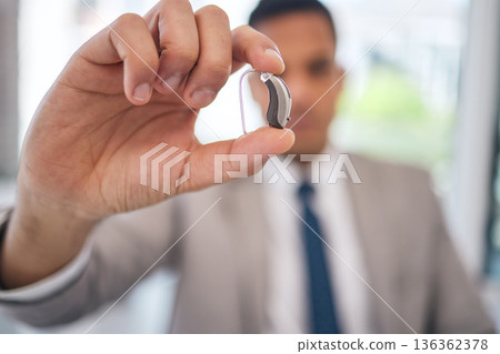 Hand, business man and hearing aid for ear, sound amplifier and audio communication in company office. Professional, person with a disability and deaf with implant technology to help with listening 136362378