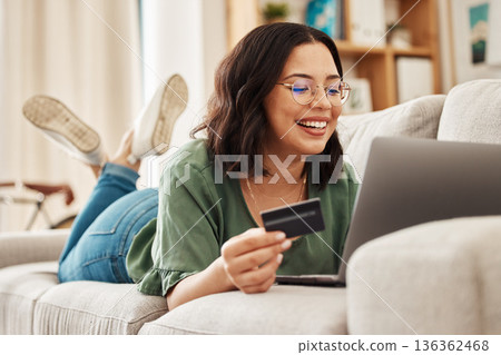 Relax, laptop and credit card, happy woman on couch in living room for internet banking in home for online shopping. Ecommerce payment, smile and cashback, girl on sofa with computer and website sale 136362468
