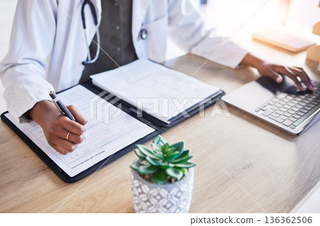 Doctor hands, insurance and writing at desk, typing and laptop for report, results or ideas for healthcare. Medic, book and pen for paperwork, compliance and info in notebook by computer in hospital Doctor hands, insurance and writing at desk, typing and laptop for report, results or ideas for healthcare. Medic, book and pen for paperwork, compliance and info in notebook by computer in hospital 136362506