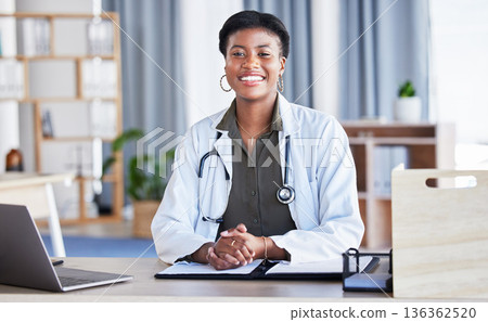Black woman, portrait and doctor in office for medical services, advice and consulting in clinic. Happy female therapist, healthcare worker and consultant at desk in hospital for wellness management Black woman, portrait and doctor in office for medical services, advice and consulting in clinic. Happy female therapist, healthcare worker and consultant at desk in hospital for wellness management 136362520