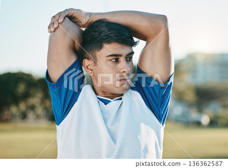 Man, soccer field or football player stretching arms thinking of training, exercise or workout in Brazil. Fitness, warm up or male athlete ready to start practice match or sports game in stadium 136362587
