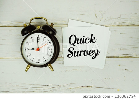 Quick Survey text with eye glasses and magnifying glass on wooden background Quick Survey text with eye glasses and magnifying glass on wooden background 136362754