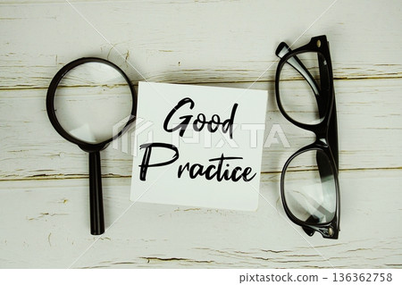 Good Practice text with eye glasses and magnifying glass on wooden background 136362758