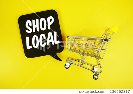 Shop Local text with trolley shopping cart on yellow background Shop Local text with trolley shopping cart on yellow background 136362817