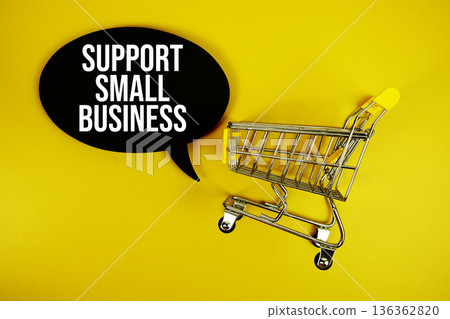 Support Small Business text with trolley shopping cart on yellow background Support Small Business text with trolley shopping cart on yellow background 136362820
