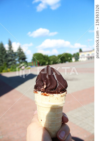 Ice cream in hand. Cold dessert in summer Ice cream in hand. Cold dessert in summer 136363326